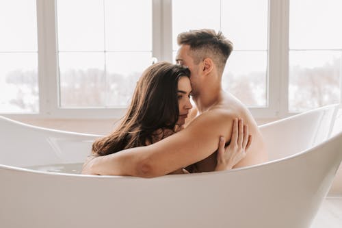 Man and Woman Kissing in Bathtub