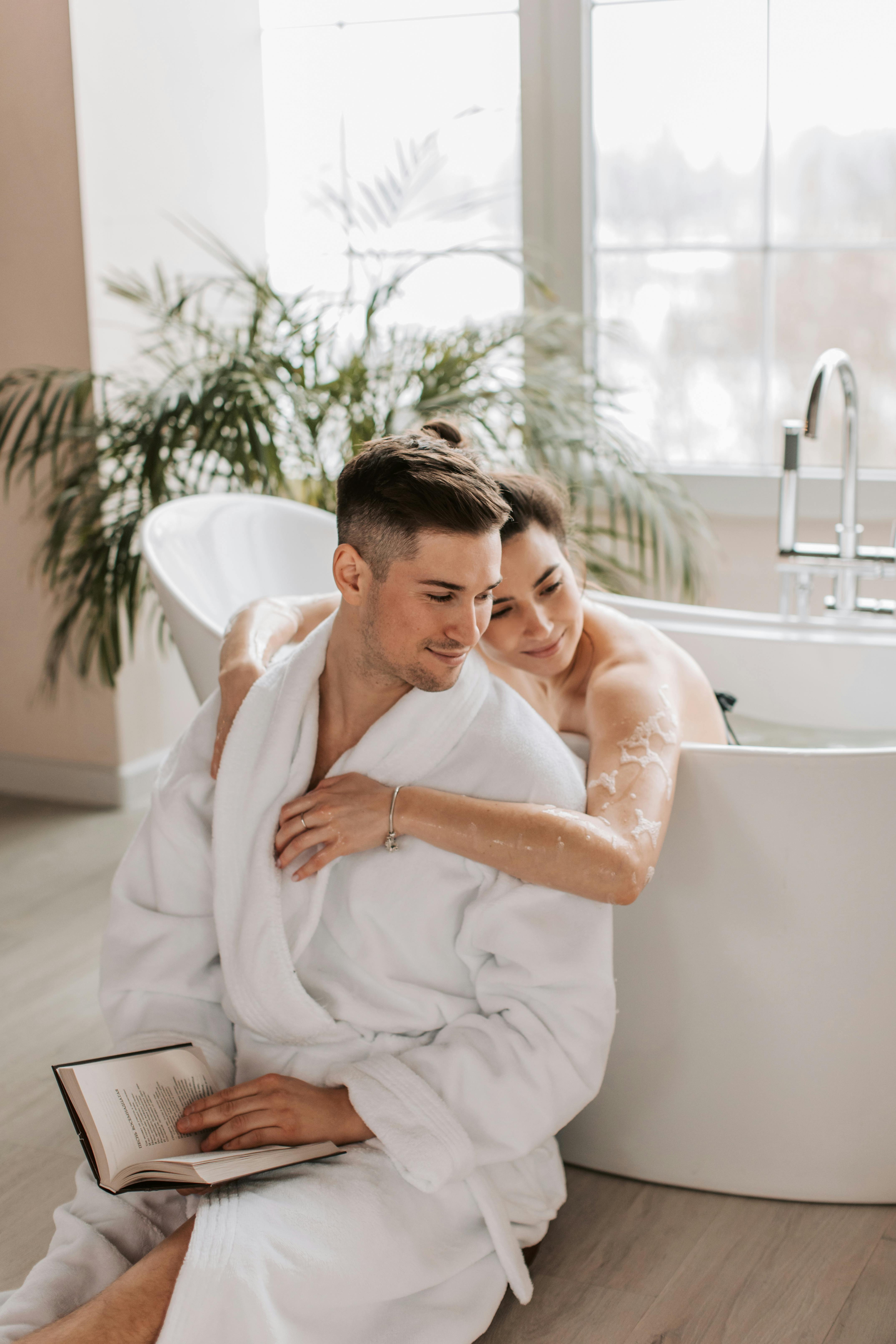 Man Sitting Beside A Bathtub With A Woman Bathing · Free Stock Photo