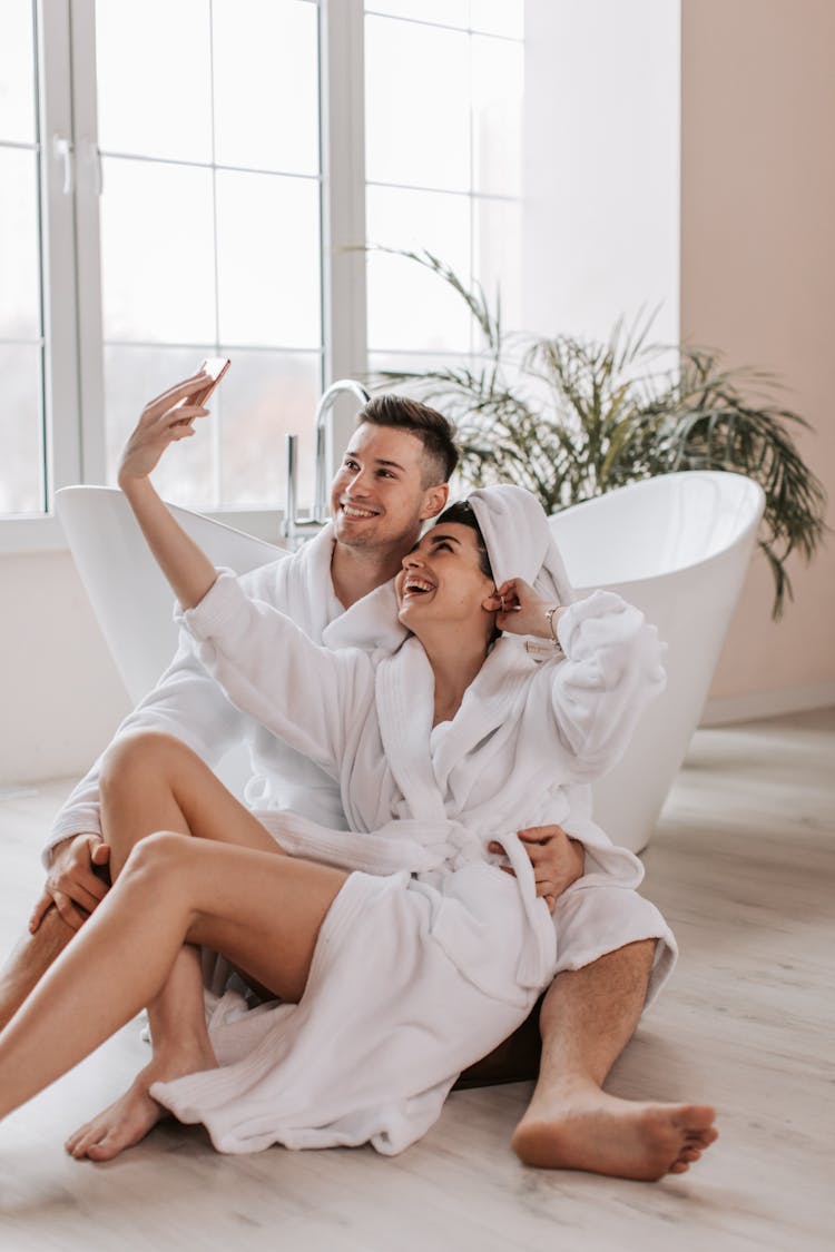 Woman Taking Selfie With A Man In The Bathroom