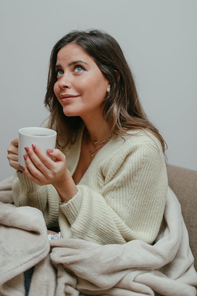 A Woman Holding A Cup Of Tea