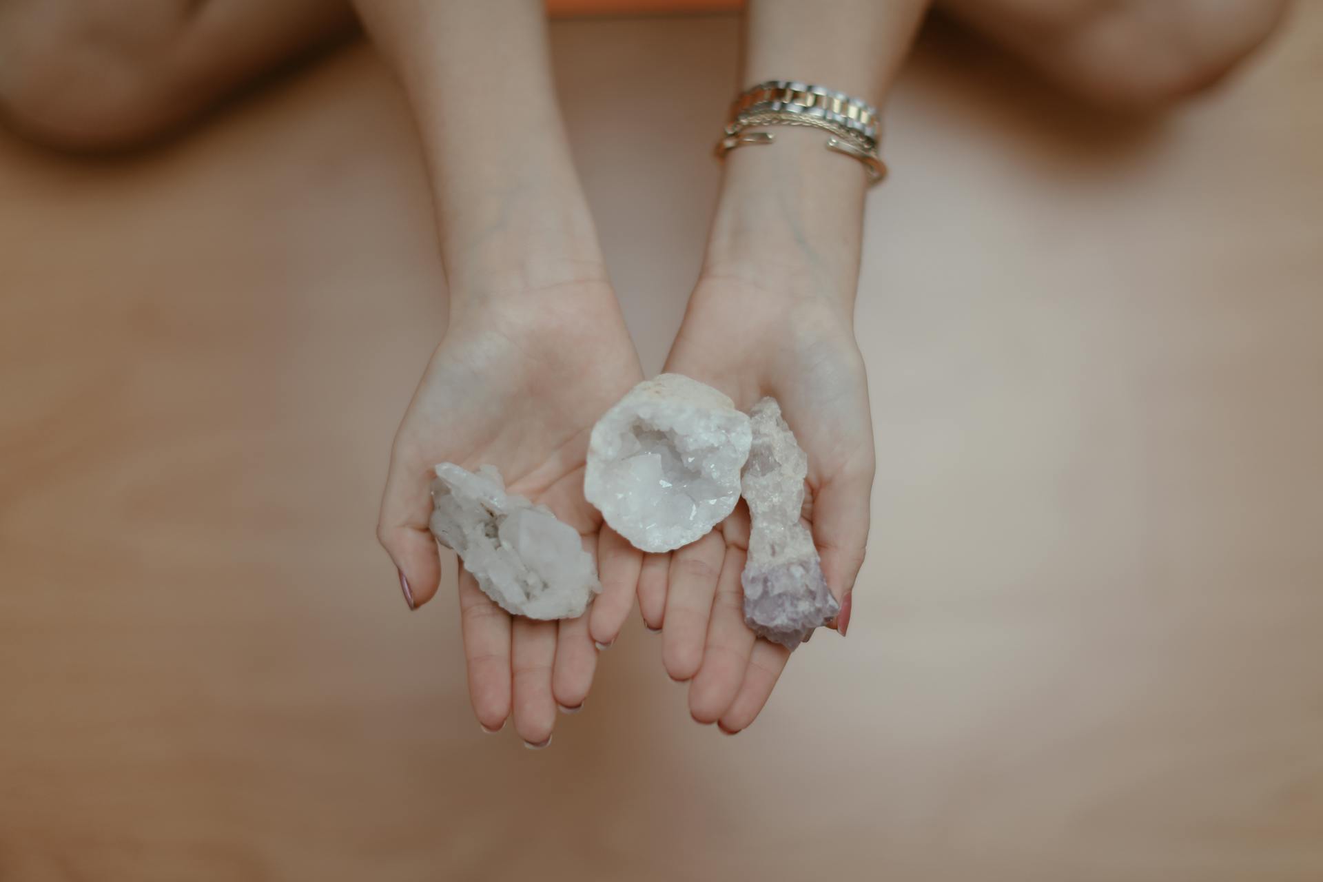 A person's hands holding healing crystals, perfect for meditation and mindfulness themes.