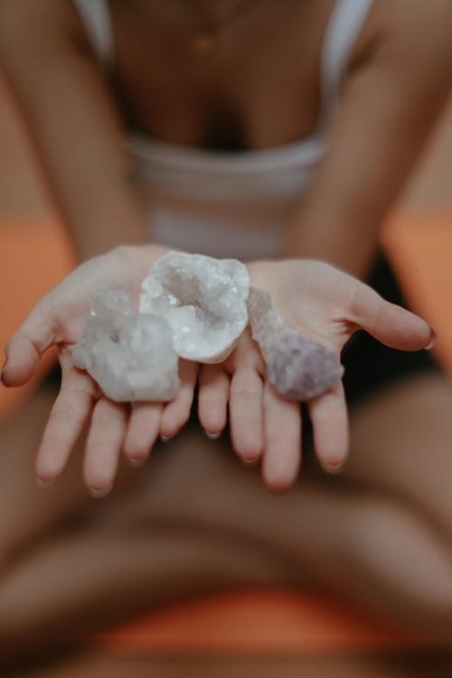 Free Close-up of crystals in hands, symbolizing mindfulness and meditation, with a blurred background. Stock Photo
