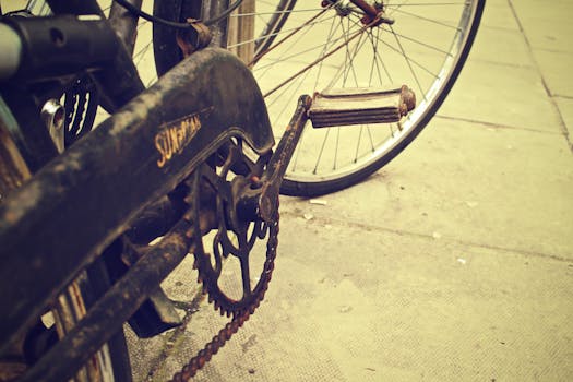 A detailed shot of an old rusty bicycle chain and pedal on a vintage bike, conveying a nostalgic feel.