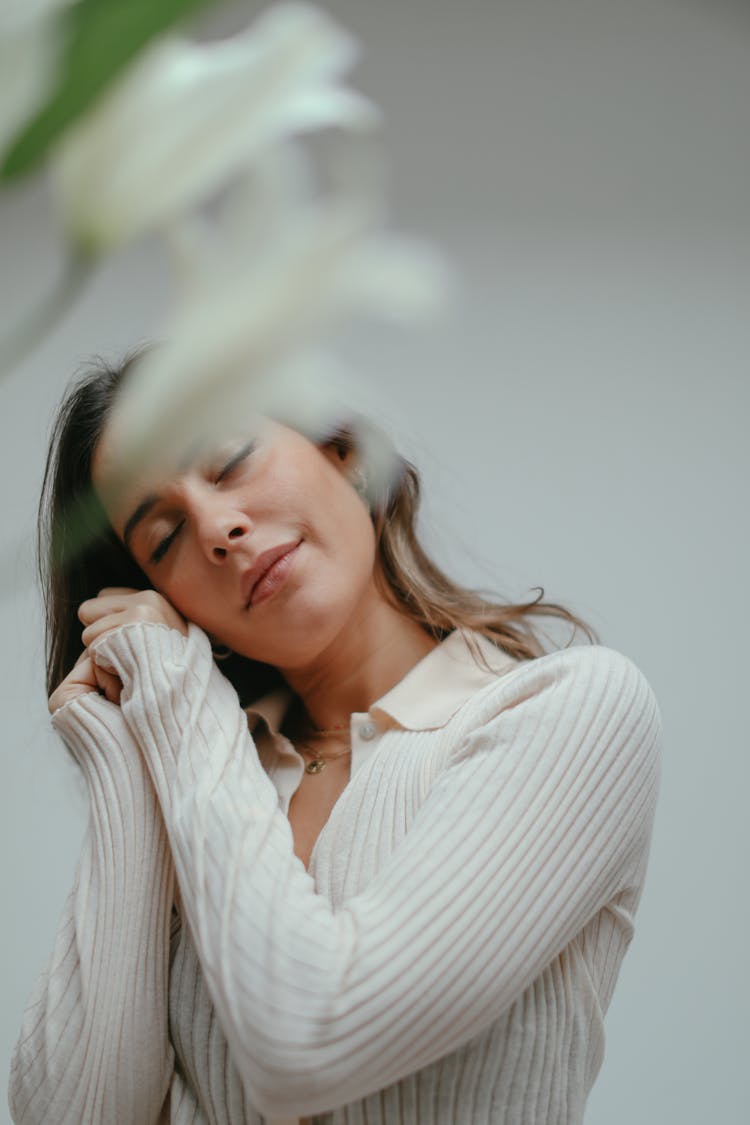 Woman With Closed Eyes Wearing A White Sweatshirt 