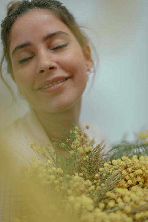 Smiling Woman Holding Yellow Flowers