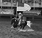 Grayscale Photo of Man Riding Horse