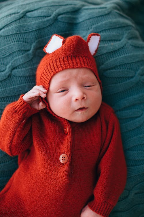 Free Cute little baby in woolen red costume Stock Photo