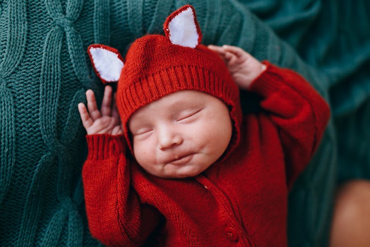 Happy Cute Funny Baby In Knitted Red Costume