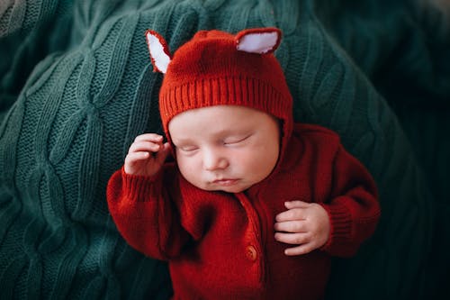 Free Funny cute newborn baby in knitted red woolen jumpers Stock Photo