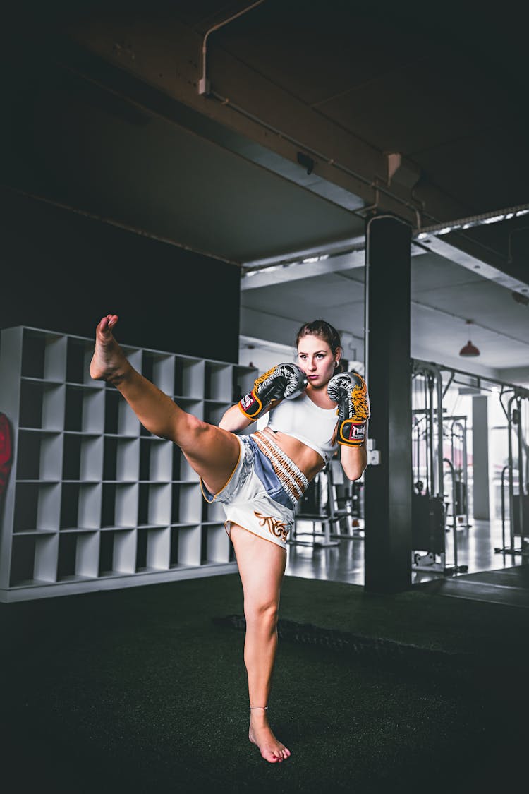 Young Woman With Leg Raised Kickboxing