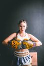 Confident young woman in boxing gloves