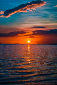 A breathtaking sunset over the ocean with colorful sky hues and tranquil waters.