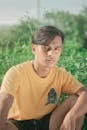 Portrait of Young Man Sitting in Grass