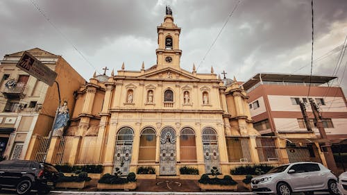 Exterior of historic Catholic church with sculptures under overcast sky