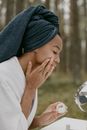 Woman in White Long Sleeve Shirt and Blue Knit Cap Holding Clear Glass Bowl
