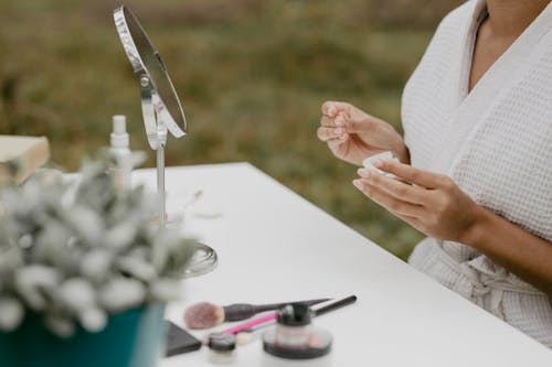 Person Holding a Cosmetic Product 