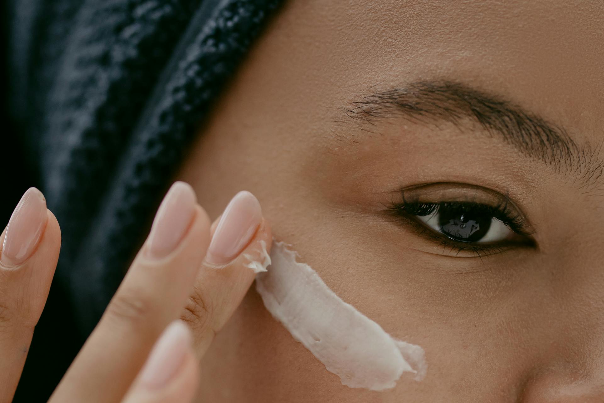 Woman applying Facial Cream on Face