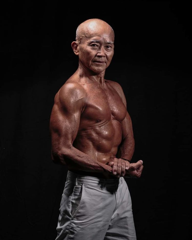 Old Muscular Man Posing Showing Muscles