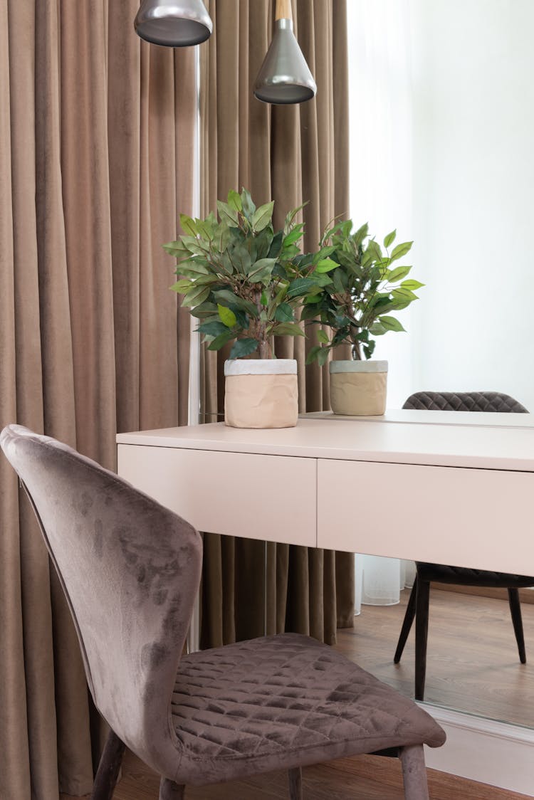 Comfortable Chair Near Table Against Big Mirror