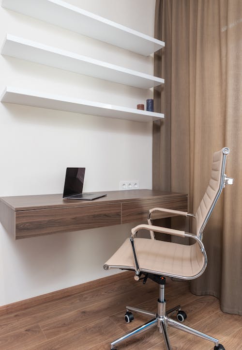 Room interior with chair near table with laptop