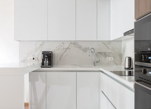 Free Tidy light kitchen interior with dining zone cupboards and appliances placed in modern apartment Stock Photo