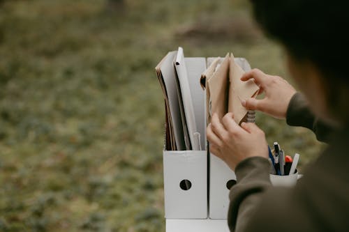 Photo of a Person Picking a Folder