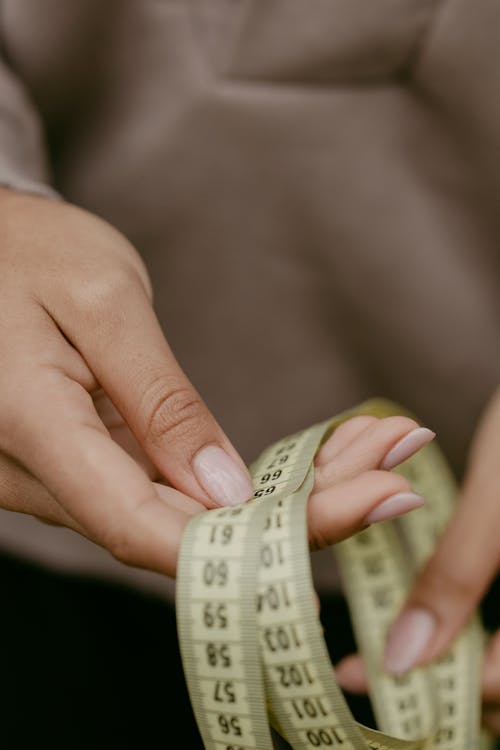 Person Holding A Tape Measure