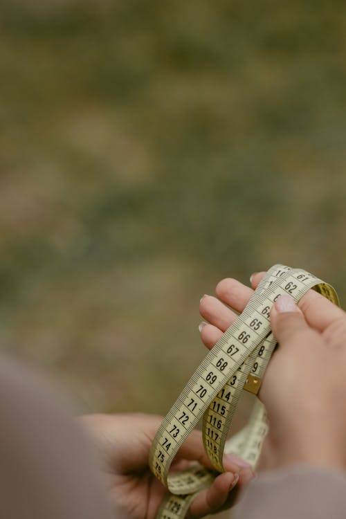 Person Holding A Measuring Tape