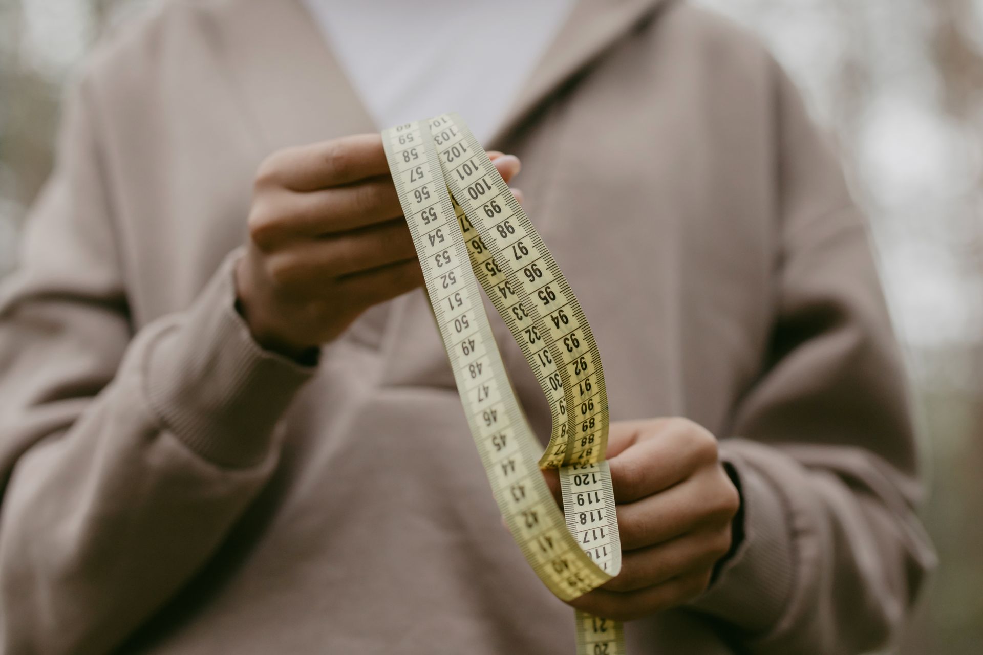 Person Holding A Tape Measure