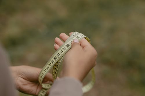 Person Holding A Measuring Tape