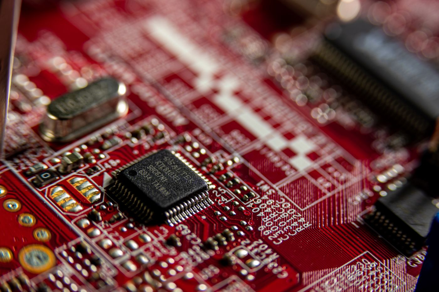 A close-up macro shot of a circuit board in shadow