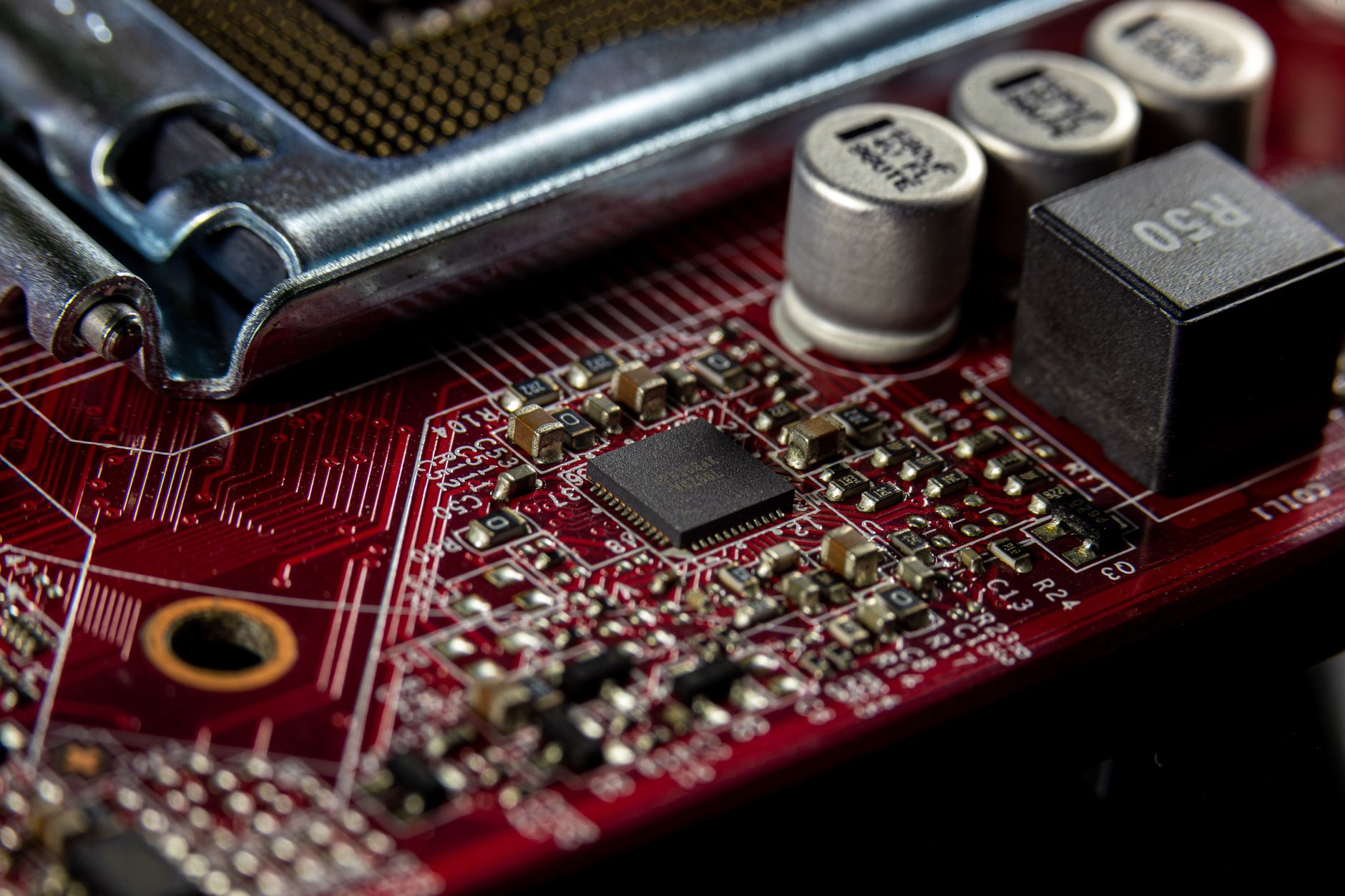 Detailed macro shot of a computer motherboard showcasing capacitors, chips, and circuits.