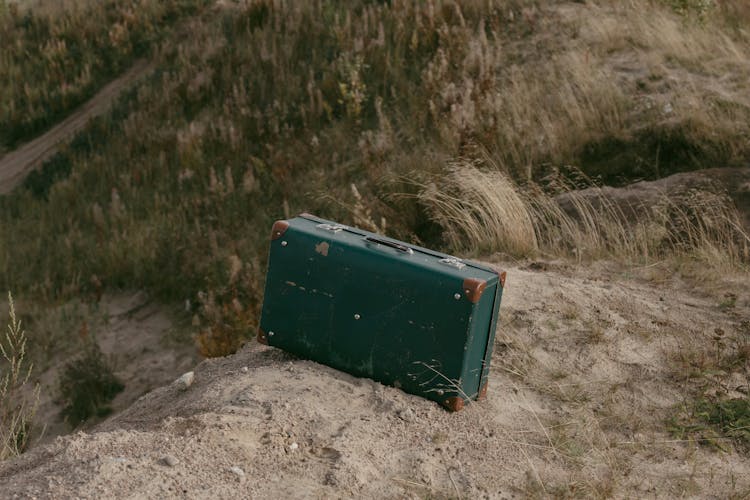 Blue Metal Suitcase On The Ground