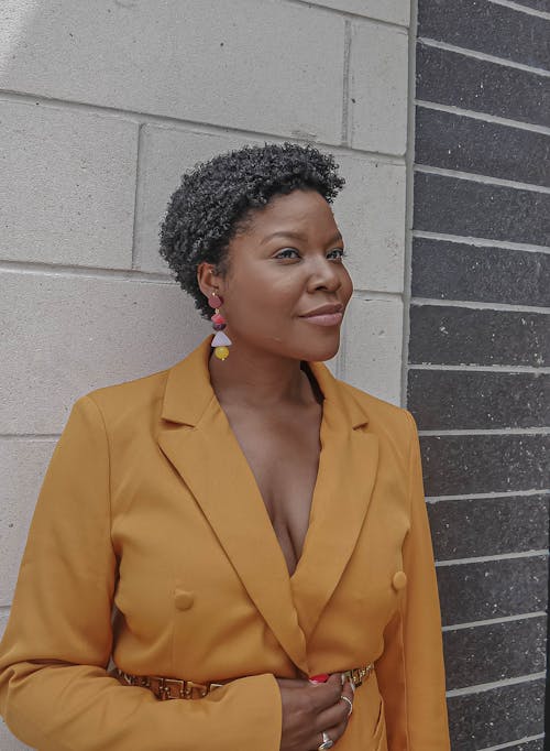 Confident young black woman standing on street and smiling