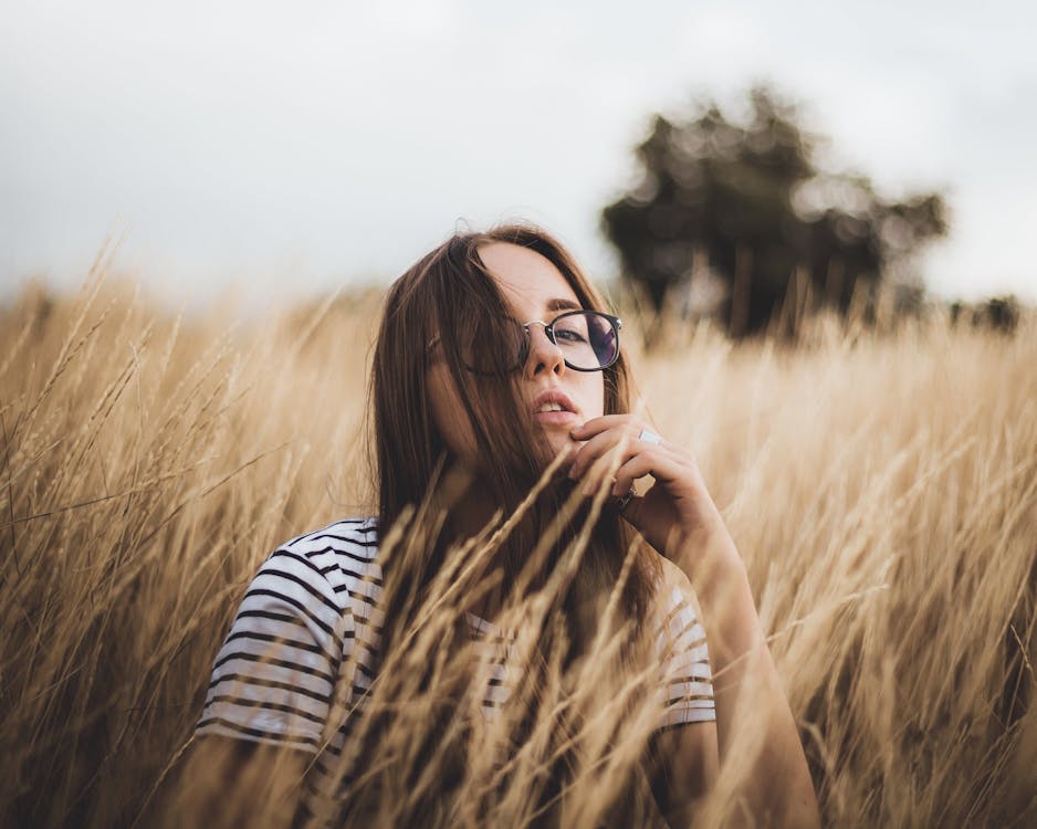 Free Self esteem young lady resting in meadow during holidays in countryside Stock Photo