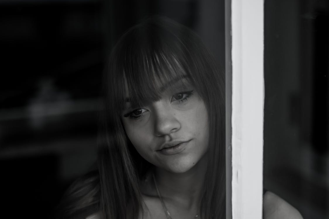 Free A Grayscale Photo of a Woman Looking at the Window Stock Photo