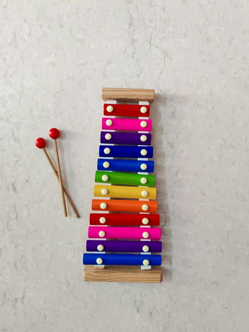 Free Top view of a vibrant xylophone with mallets on a marble background, perfect for music-themed content. Stock Photo