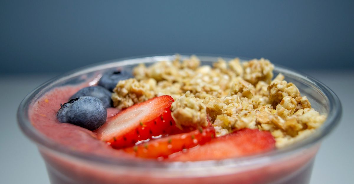 Photo by Saskia Healthy acai bowl topped with fresh strawberries, blueberries, and granola in a close-up view.