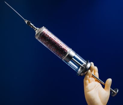 Person Holding A Syringe Injection