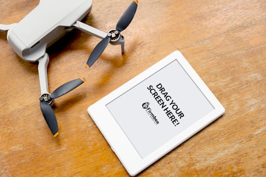 Drone and tablet on a wooden table, illustrating modern tech gadgets.