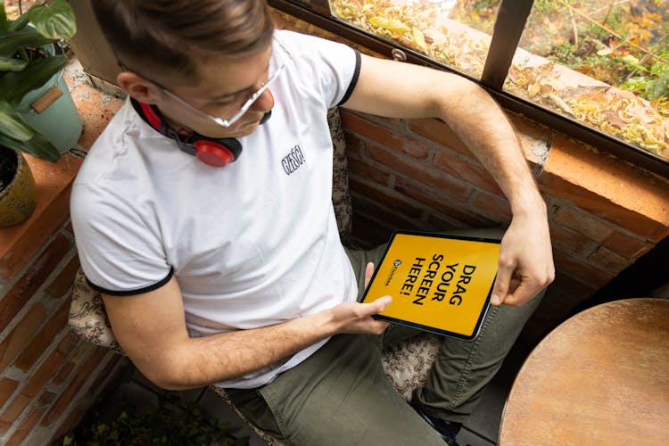 Man With Headphones Using A Digital Tablet