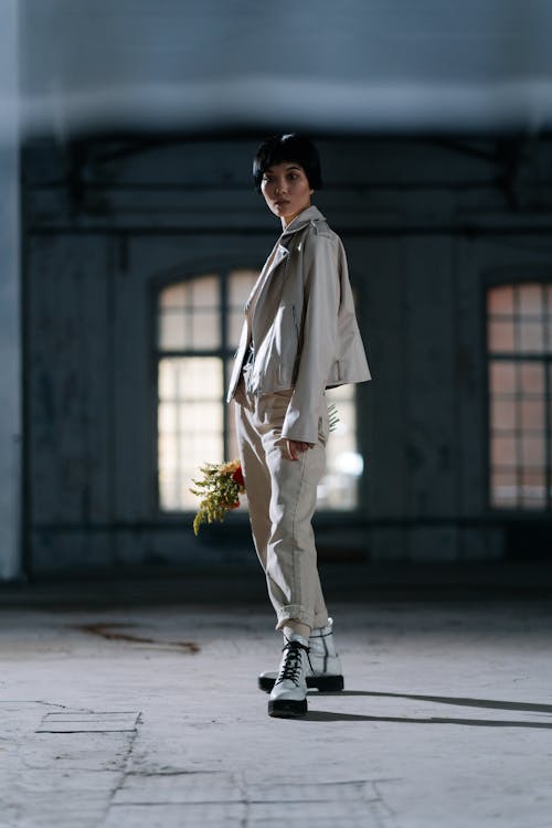 A Stylish Woman Posing While Holding a Flower Bouquet