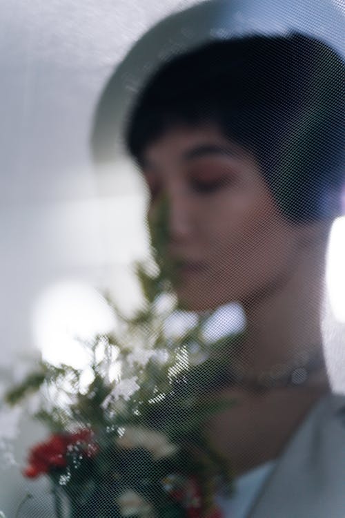 Woman Smelling a Bunch of Flowers