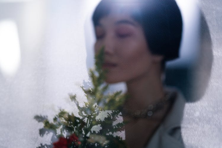 Close Up Photo Of Woman Smelling Flowers