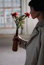 Person Holding Red and White Flowers