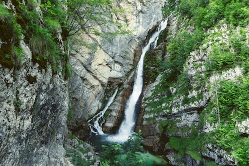 Water Falls Between Gray Rocky Mountain