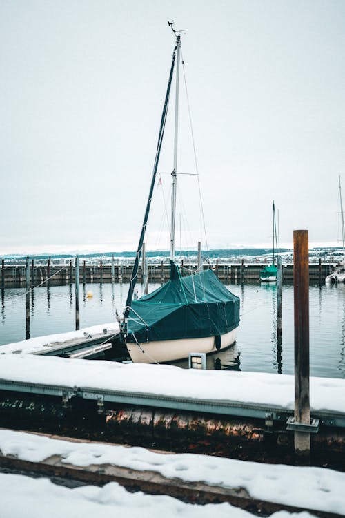 Blue and White Sailboat on Dock