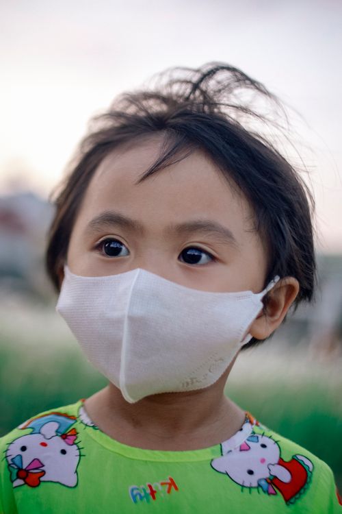 Free Close-up of a child wearing a mask, with a soft background. Stock Photo