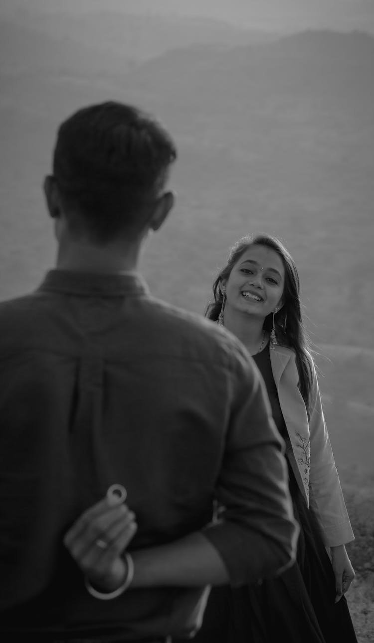 A Back View Of A Man Proposing To His Girlfriend