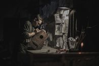 Man in Black Jacket Playing Brown Acoustic Guitar